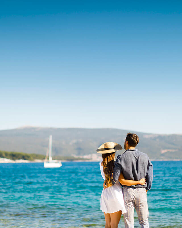 Couple enjoying a romantic seaside view in Kvarner, Croatia