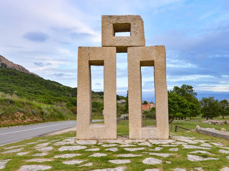Glagolitic letter stone sculpture on the Croatian landscape