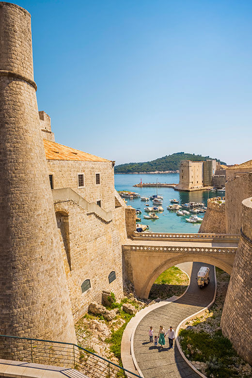 Historic stone walls and harbor of Dubrovnik Old Town, UNESCO World Heritage site.