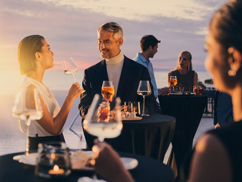 Gli ospiti si godono cocktail in un rooftop bar in Croazia al tramonto