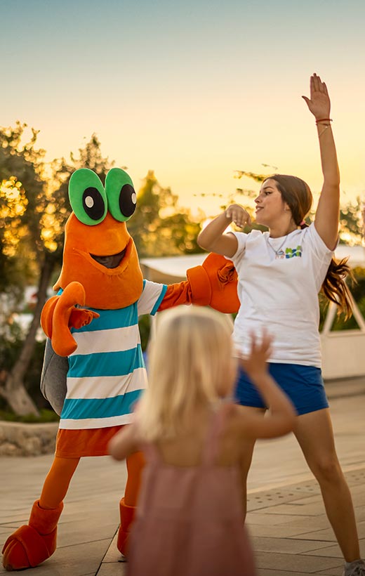 Animator and the Maro mascot dancing with a little girl at sunset at Valamar Diamant Hotel