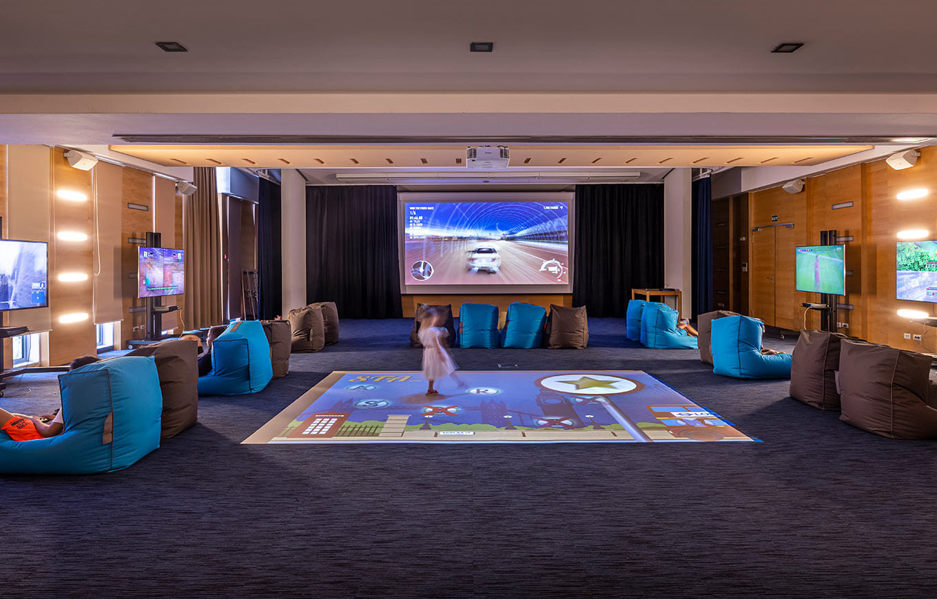 Modern Game Lounge & Theatre with interactive games and a large screen at Valamar Diamant Hotel.
