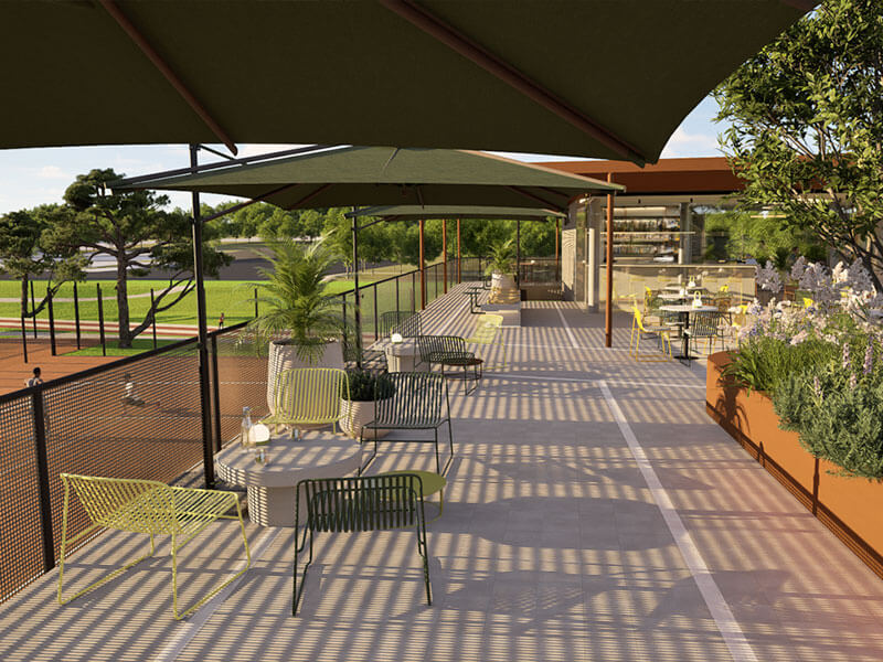 Outdoor terrace with seating overlooking the tennis courts at Racket Club, Valamar Diamant Hotel.