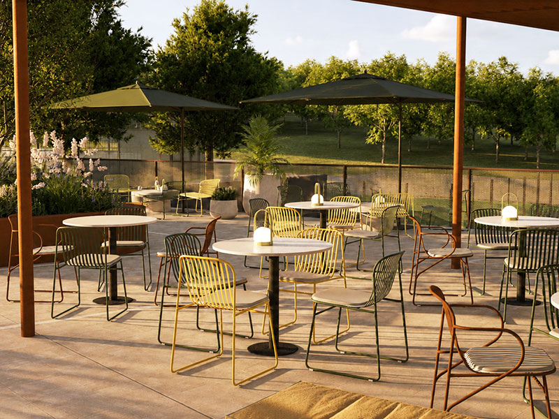 Outdoor terrace with tables and chairs overlooking the tennis courts at Racket Club.