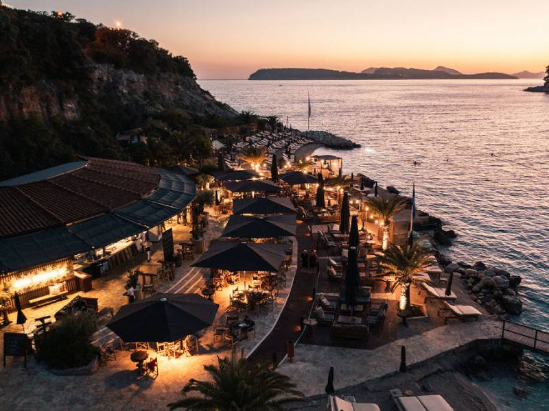 Sunset view of Coral Beach Club Dubrovnik with beachfront seating
