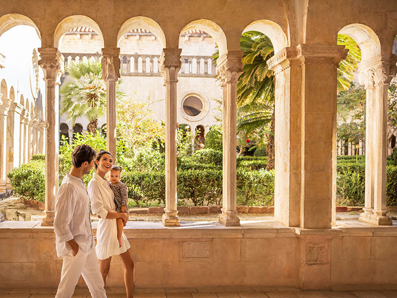 Historic cloister arches framing a scenic lookout in Dubrovnik
