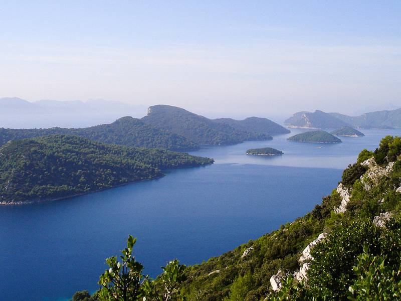 Hilly green coastline and clear waters of the Elaphiti Islands