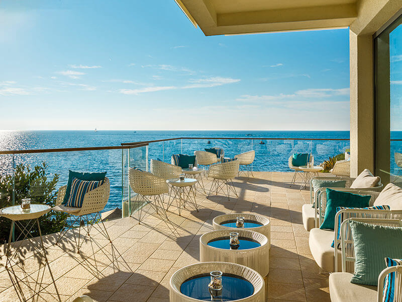 Sonnige Terrasse der Miramare Lobby Bar mit Meerblick.