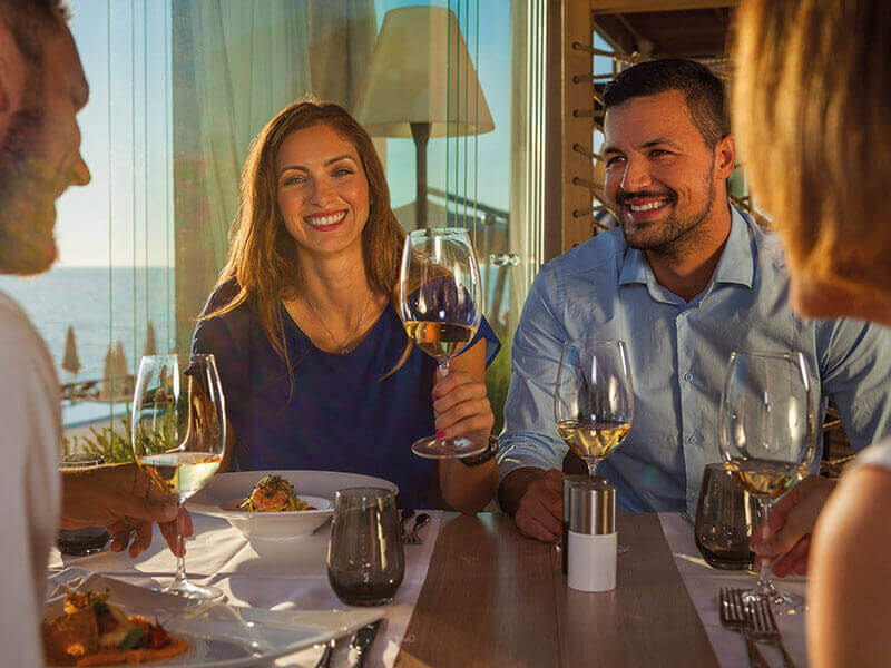 Gruppe von Menschen isst und trinkt Wein in einem Restaurant im Isabella Island Resort.