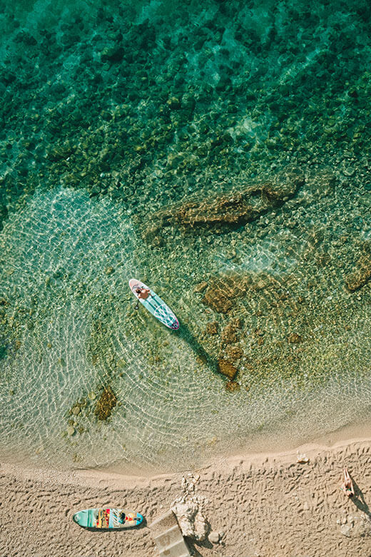 Crystal-clear beach with kayak and boat 