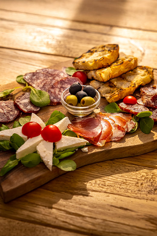 Traditional Istrian charcuterie board with prosciutto and grilled bread