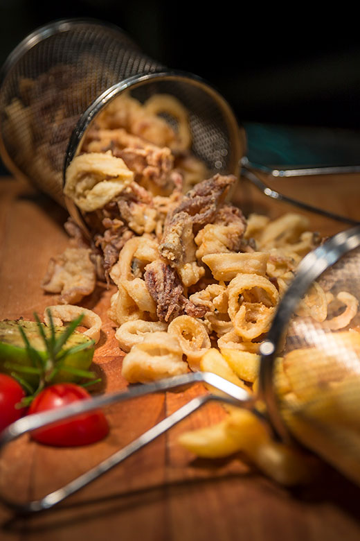 Traditional fried calamari served with fresh vegetables in Kvarner, Croatia’s renowned food and wine destination.