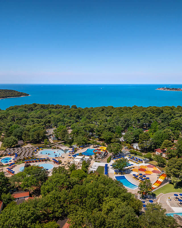 Aerial view of Valamar Camping Lanterna near Poreč with pools, mobile homes, pine forest and Adriatic Sea coastline