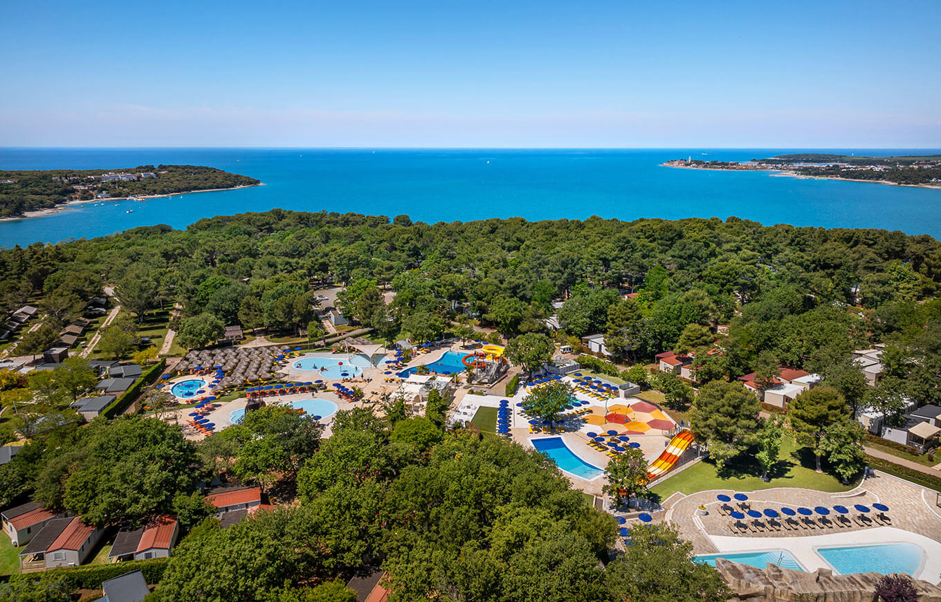 Aerial view of Valamar Camping Lanterna near Poreč with pools, mobile homes, pine forest and Adriatic Sea coastline