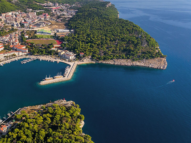 Osejava Peninsula with rocky coastline and Makarska town view