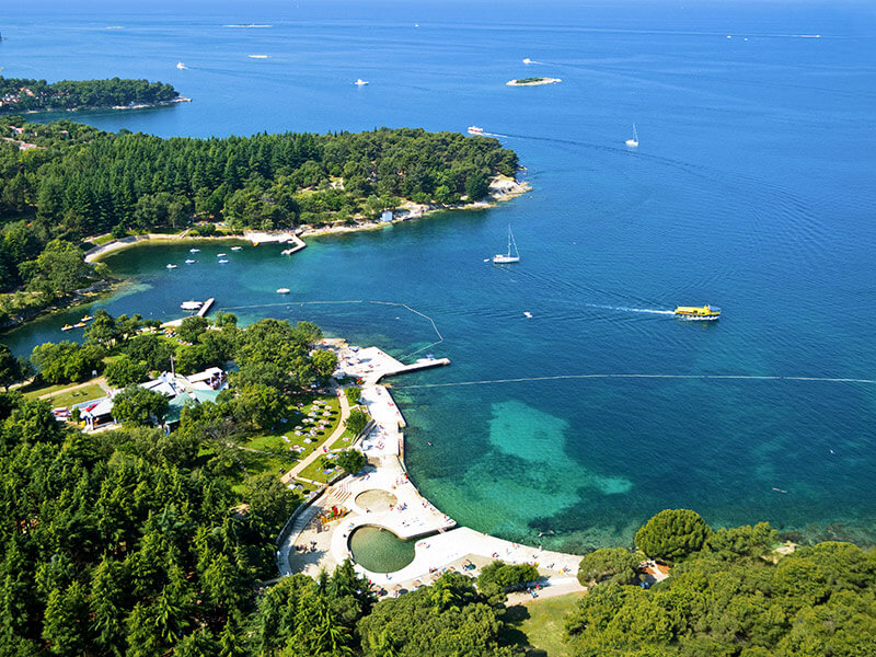 Aerial view of Brulo Beach and lush forest near Poreč