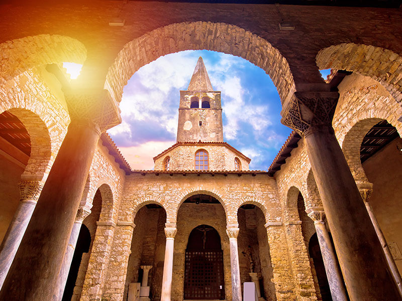 Interior view of the Euphrasian Basilica Complex with ornate mosaics and arches