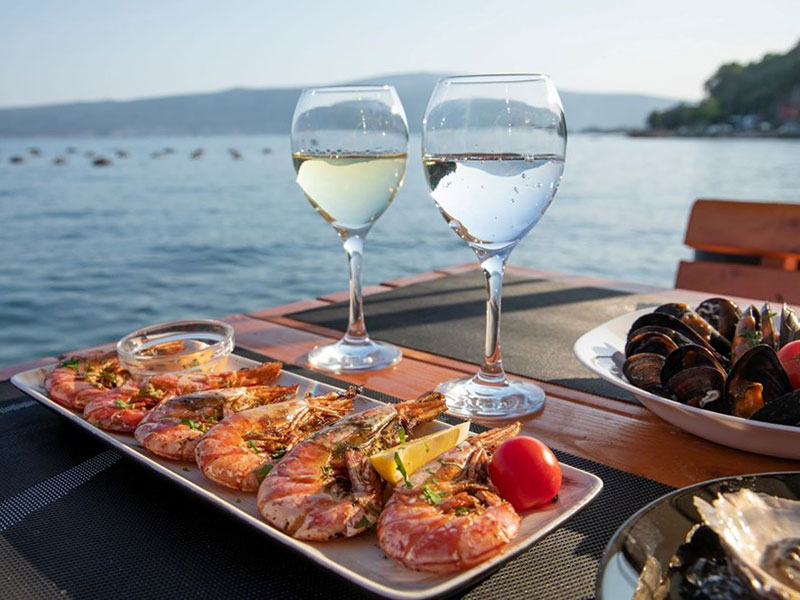 Fresh seafood and wine served at seaside restaurant in Istria