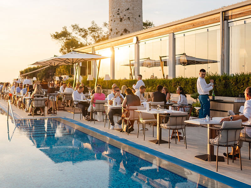 Miramare by Fratelli Cerea restaurant terrace with sunset dining by the sea