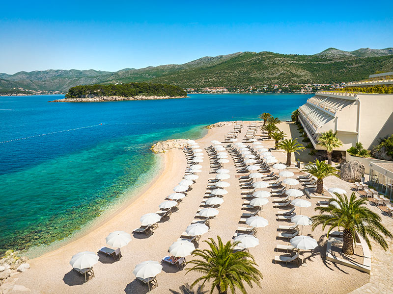 A family spending quality time on the Val Maro Sandy Beach at Valamar Isabella Island Resort.