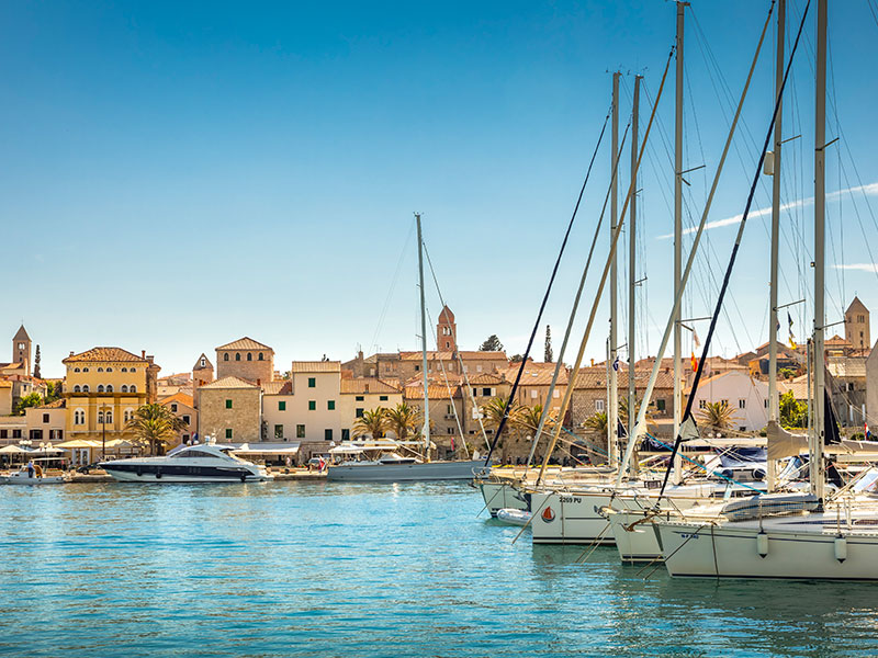 Marina with sailboats and historic buildings on Rab Island, Croatai