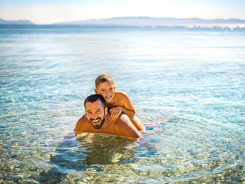 Family playing in the sea at a gentle-sloped beach