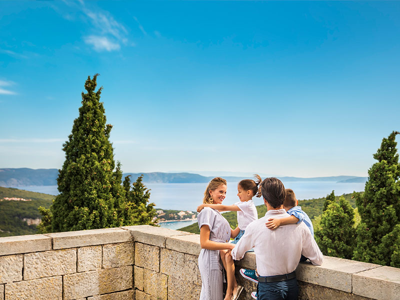 Family admiring the coastal view from a scenic terrace in Labin