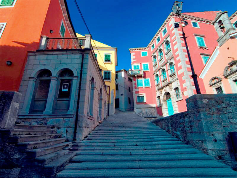 Colorful palaces and stone staircase in Labin’s historic district