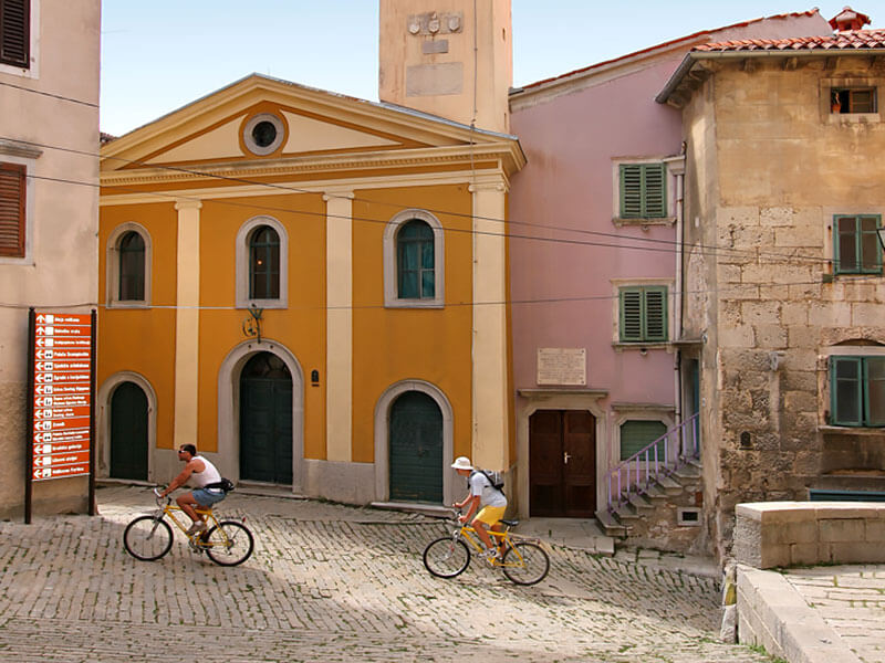 Small historic theater with orange and pink façades