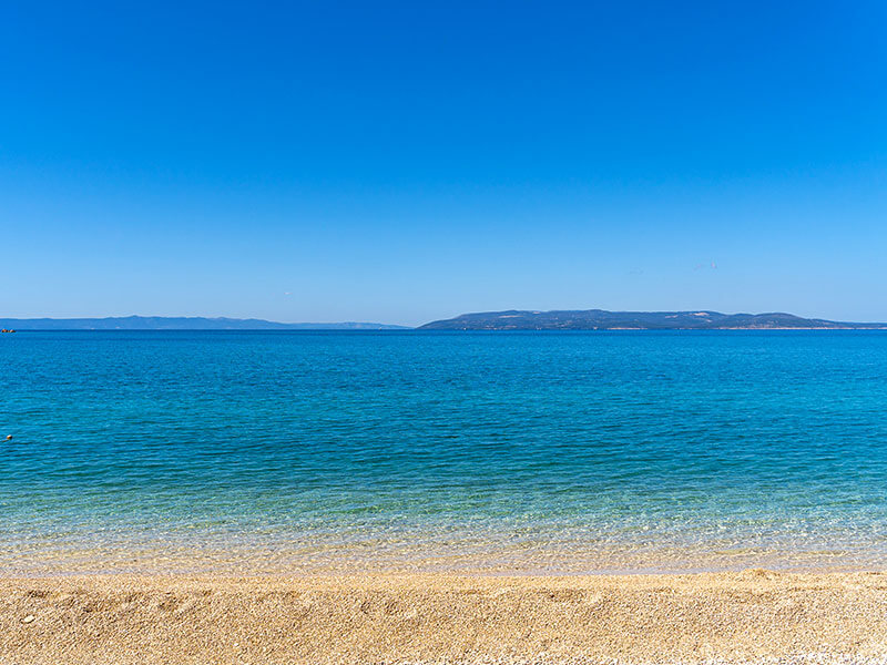 Maslinica beach, a popular pebble beach in Rabac for families and swimmers