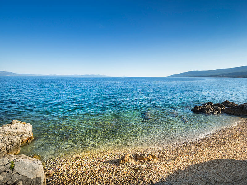 Idyllic cove with shimmering water and natural rock formations