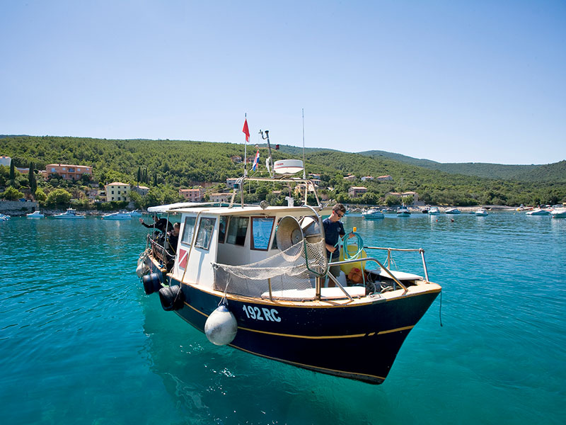 Sightseeing boat anchored off the coast of Rabac