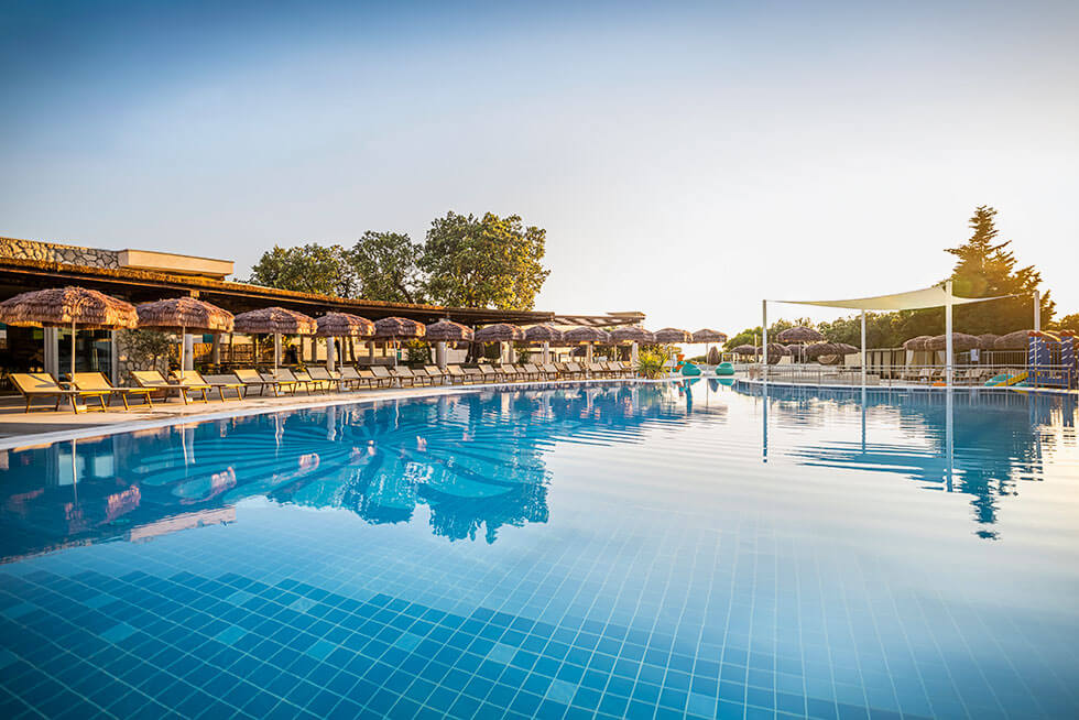 Outdoor pool with sun loungers and umbrellas at Valamar Tirena Hotel, a 4-star family-friendly hotel located on the scenic Babin Kuk peninsula in Dubrovnik, Croatia