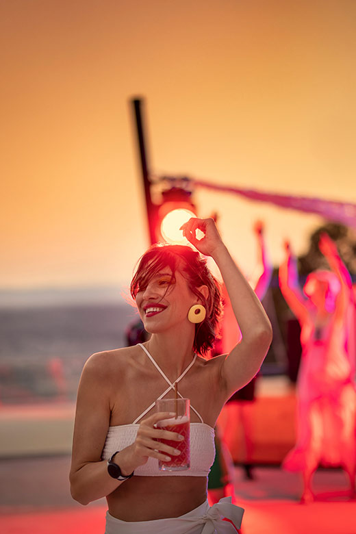 Woman dancing with a cocktail in hand