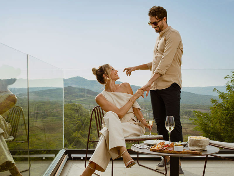 Elegant couple drinking wine on a terrace in Istria