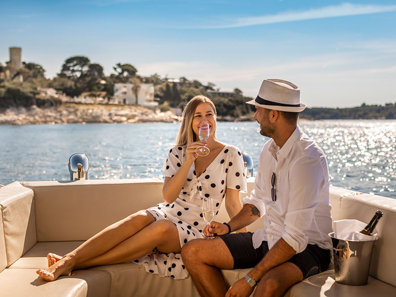 Couple sipping champagne on a boat that takes you to Isabella Island Resort in Poreč