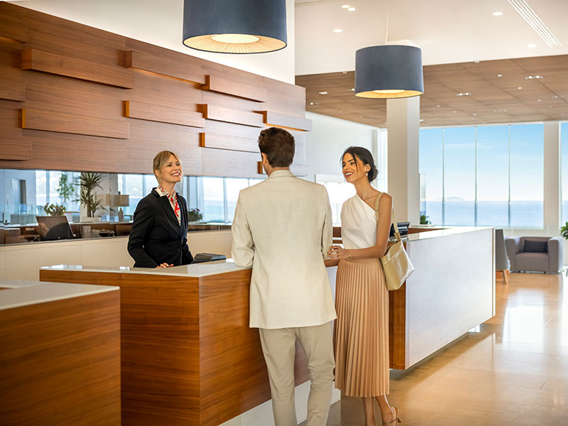 Couple beginning their luxury holiday with a check-in at the Valamar Experience Concierge hotel reception